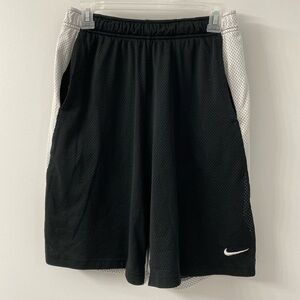 Nike athletic men’s shorts - size medium. Mesh material outer layer